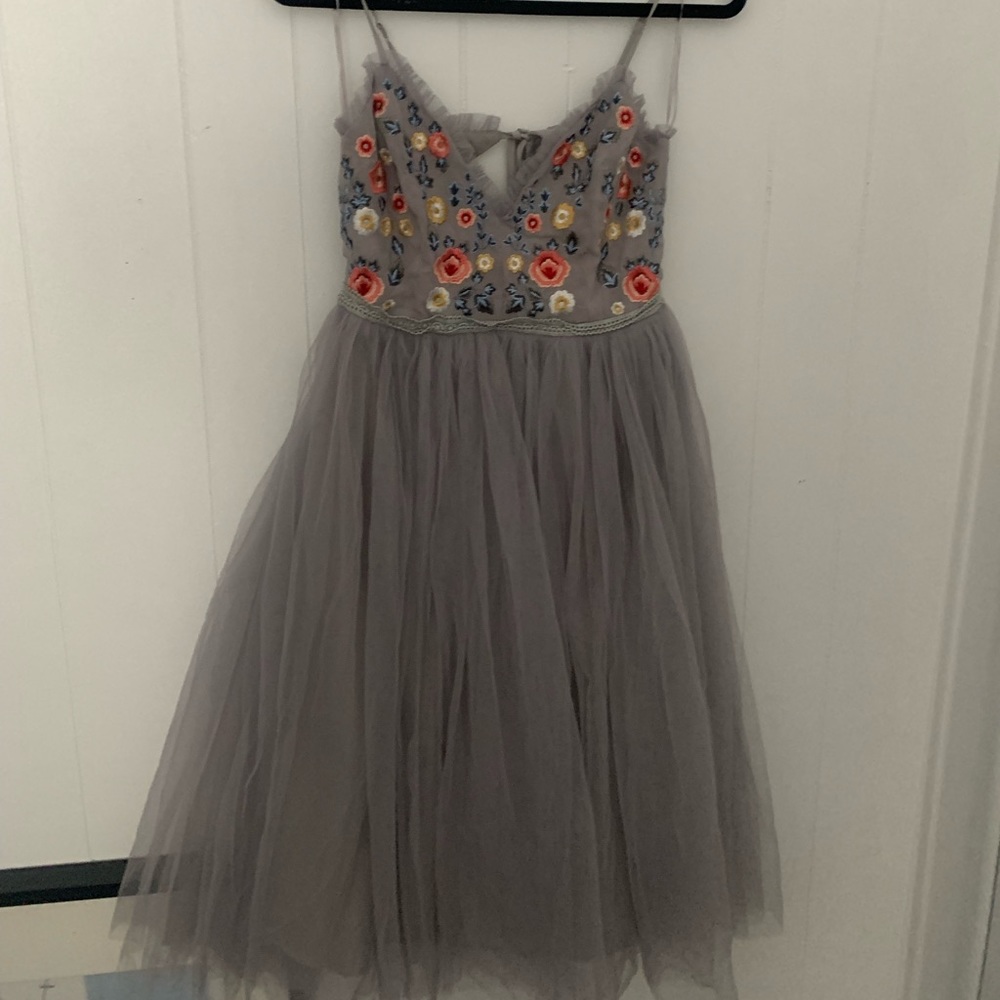 Gray Tulle dress with embroidered flower patterned top.